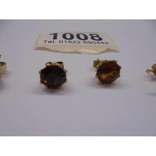 1008 - Three pairs of yellow metal stud earrings.