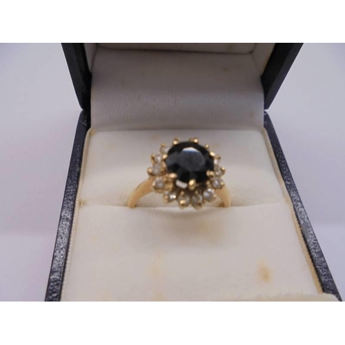 1015 - A gold sapphire and diamond ring, hall mark faded, size M half, 3.9 grams.