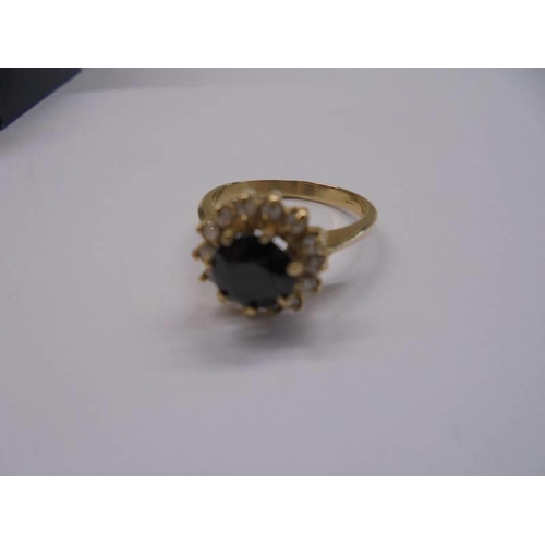 1015 - A gold sapphire and diamond ring, hall mark faded, size M half, 3.9 grams.