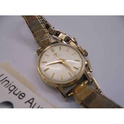 1016 - A Tissot lady's wrist watch marked USA 10K Gold top.