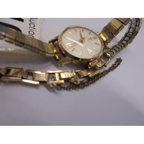 1016 - A Tissot lady's wrist watch marked USA 10K Gold top.