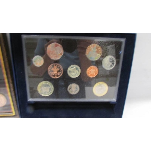 1125 - A framed and glazed British Monarchs coins, a 2004 proof coin set and a Henry VIII £5 coin.