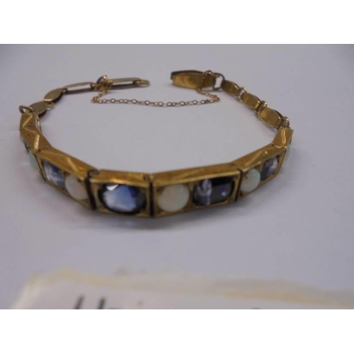 1024 - A gold bracelet set opals and sapphires with safety chain, (tests as 18ct,) 8.9 grams