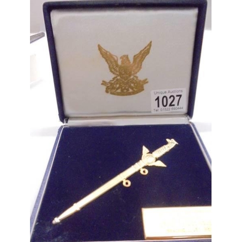 1027 - A cased RAF presentation dagger in yellow metal.