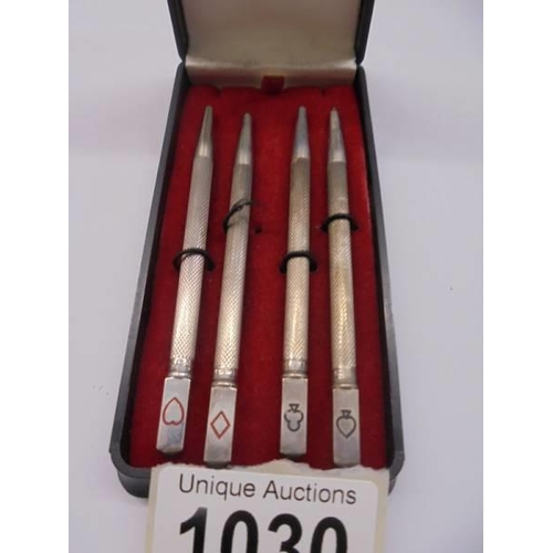 1030 - A cased set of four silver bridge pencils.