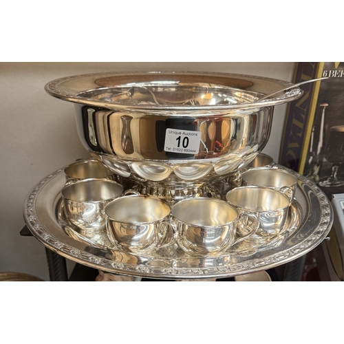 10 - A large silver plated punch bowl on tray with ladle and drinking vessels