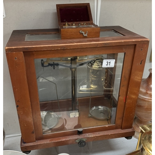 31 - A vintage cased chemist scales with weights