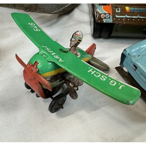 74 - A West German tinplate clockwork plane, friction tank and car