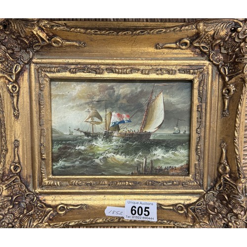 605 - A gilt framed overpainted print of a seascape.