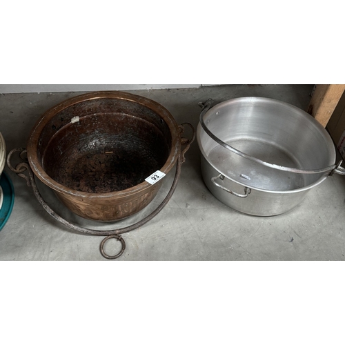 93 - An old copper jam pan with iron handle and an aluminium example