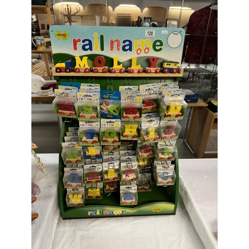 120 - A shop display stand with a quantity of wooden letters etc by Big Jigs Rail