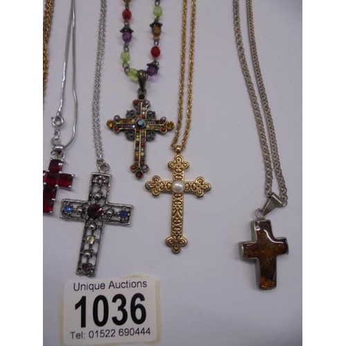 1036 - Eight assorted cross pendants including an amber example.