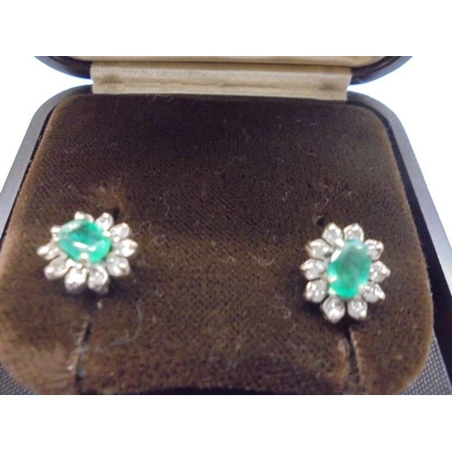 1037 - A pair of cluster stud earrings set green stones and diamond chips.