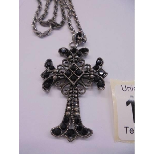 1038 - A good quality cross pendant set black stones.