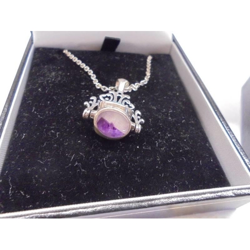 1047 - A silver pendant set three stones and a silver ring set large purple stone.