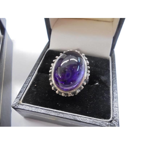 1047 - A silver pendant set three stones and a silver ring set large purple stone.