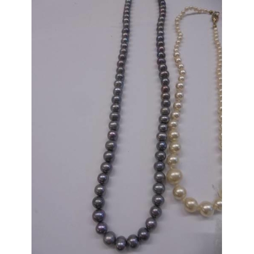 1048 - Three coloured pearl necklaces and a pair of pearl earrings.