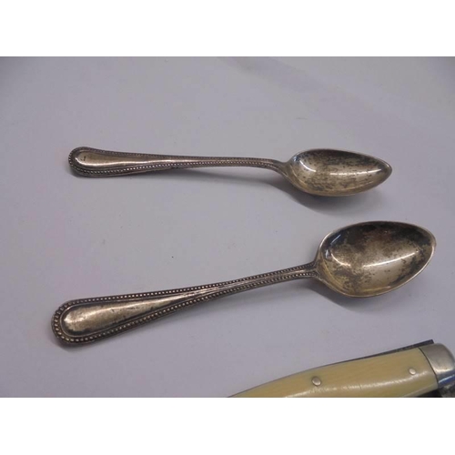 1051 - Two silver teaspoons and a double bladed penknife.