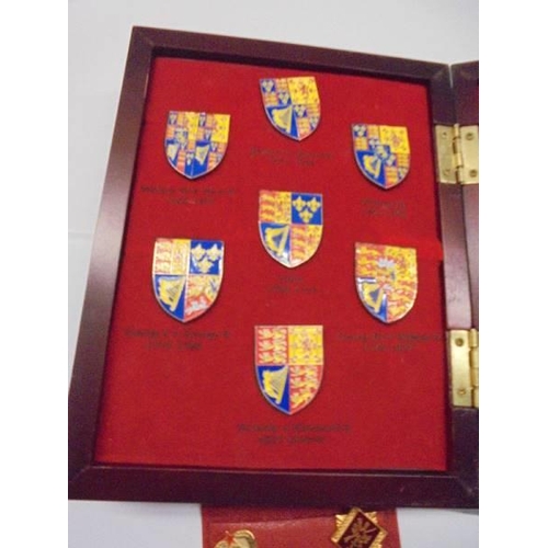 1137 - A cased set of Kings & Queens of Great Britian coats of arms and five Russian badges.