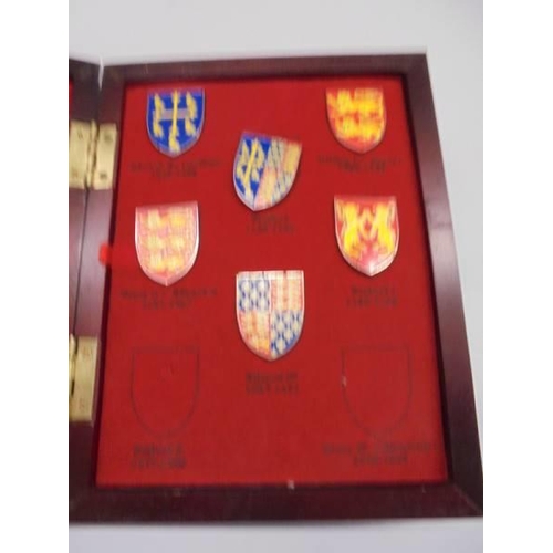 1137 - A cased set of Kings & Queens of Great Britian coats of arms and five Russian badges.