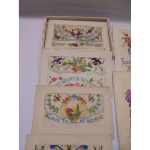 1138 - Eight early 20th century silk greeting cards and a Jerusalem souvenier booklet with dried flowers.