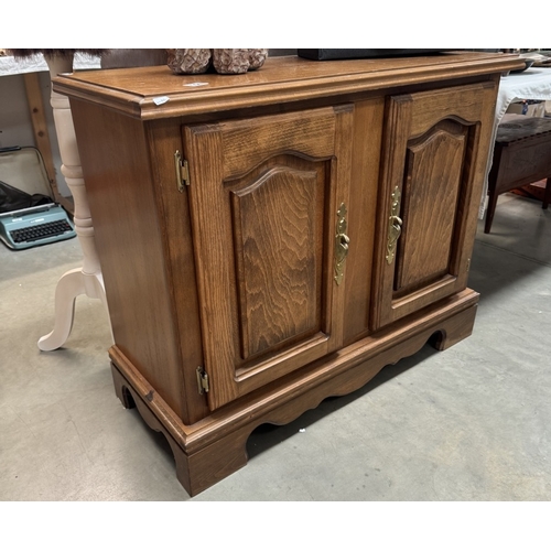 154 - A teak effect 2 door cupboard 100 x 42 x height 81cm