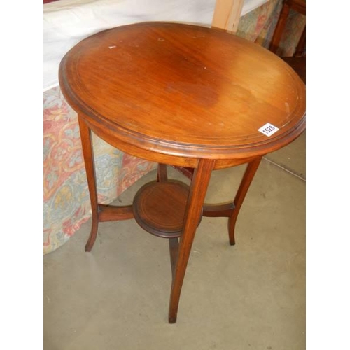 1528 - An oval mahogany inlaid occasional table. COLLECT ONLY.