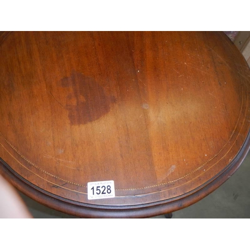 1528 - An oval mahogany inlaid occasional table. COLLECT ONLY.