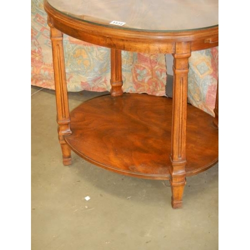 1534 - An oval oak occasional table with glass top. COLLECT ONLY.