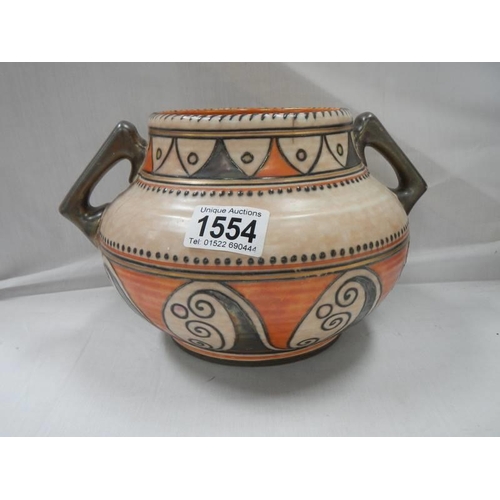 1554 - A Charlotte Rhead twin handled rose bowl, (cracks in botton).