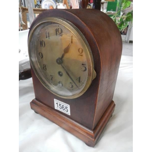 1565 - A domed top mantel clock. In working order.