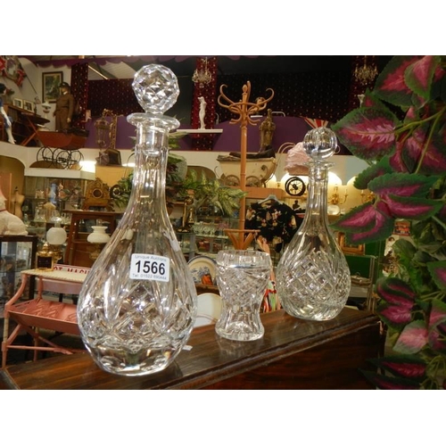 1566 - Two cut glass decanters and a cut glass vase.