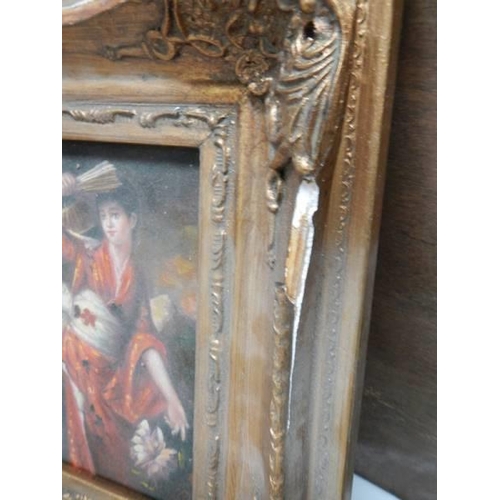 1631 - A gilt framed over painted print of a dancer.