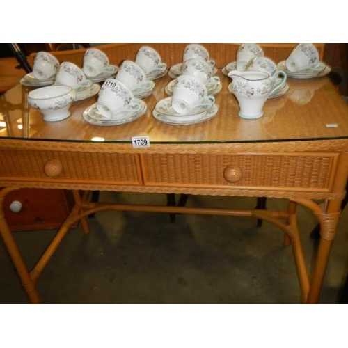 1709 - A good quality wicker side table with glass top and two drawers. COLLECT ONLY.