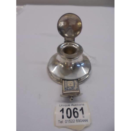 1061 - A small silver inkwell with a slot for stamps.