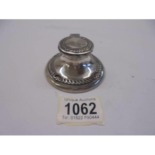 1062 - A small silver inkwell,