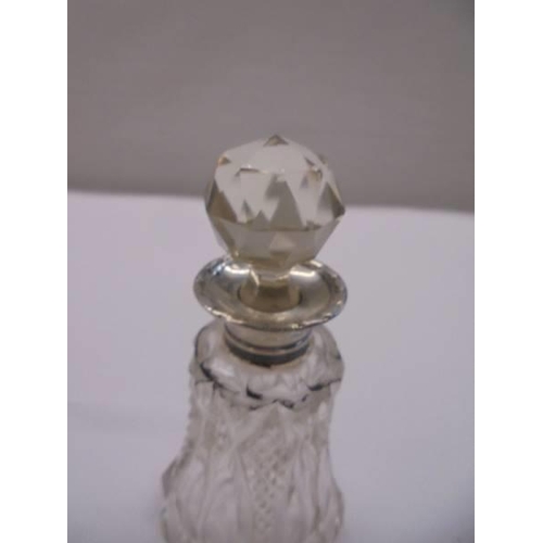 1066 - A cut glass scent bottle with silver top.