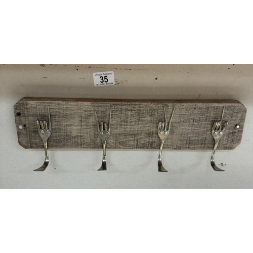 35 - A designer architectural coat rack made from reclaimed materials