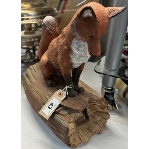 43 - A fox on a log.