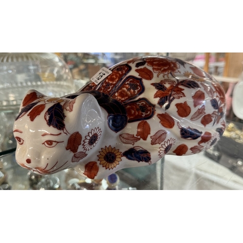 155 - A ceramic reclining cat