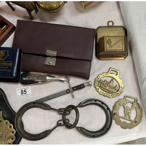 85 - A mixed lot including brass match striker, cased magnifying glass, silver plate tankards etc