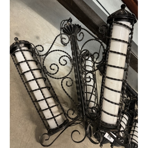 86 - A wrought iron art deco style ceiling light and 4 wall lights with white glass cylinder shades