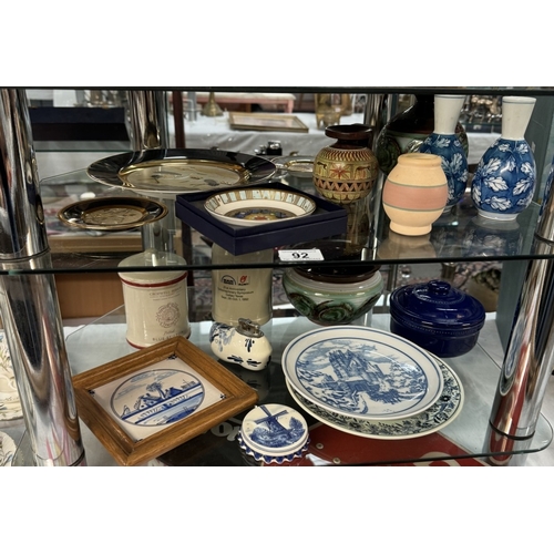 92 - A mixed lot of pottery, china etc on 2 shelves including Delft