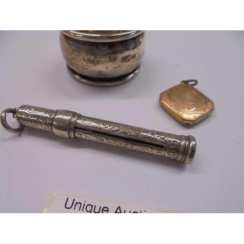 1100 - A silver napkin ring, silver pencil and yellow metal pendant.