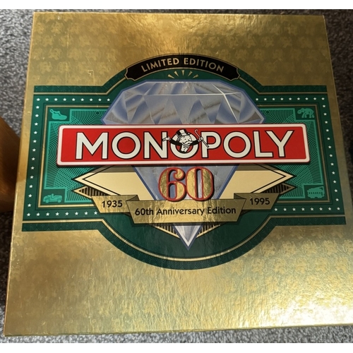 434 - A Monopoly 60th Anniversary set & Trivial Pursuit game. Both unchecked.