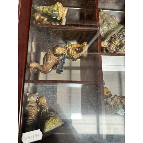 436 - 21 Wade nursery rhyme figures in display cabinet