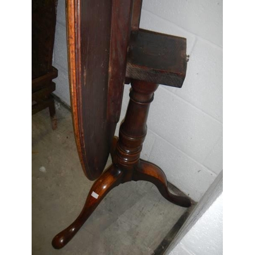 1569 - A small oval mahogany tip top table, stains to top. COLLECT ONLY.