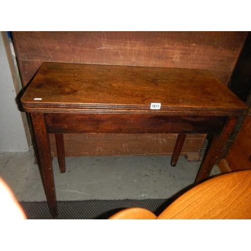 1611 - A mahogany fold over tea/games table. COLLECT ONLY.