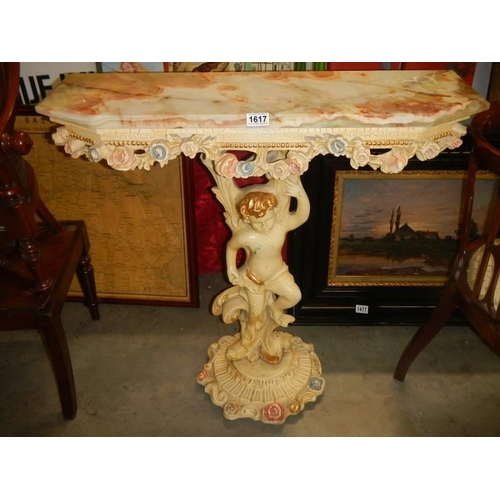 1617 - A marble topped console table supported by a cherub. COLLECT ONLY.