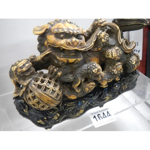 1644 - A 20th century model of a Chinese Temple Lion on a base.